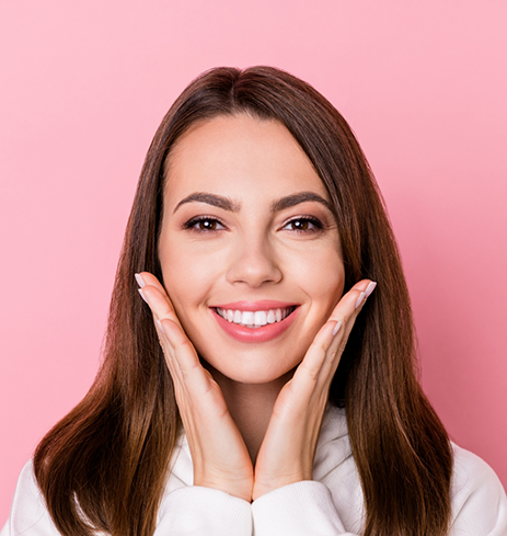 Smiling woman framing her face with her hands