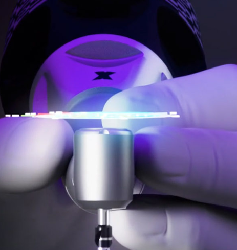 Close up of a hand adjusting an X Guide machine